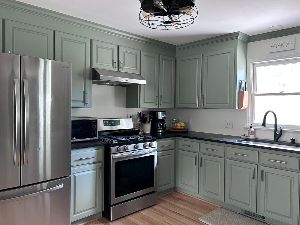 Sage green kitchen cabinets repainted by Greene Painting