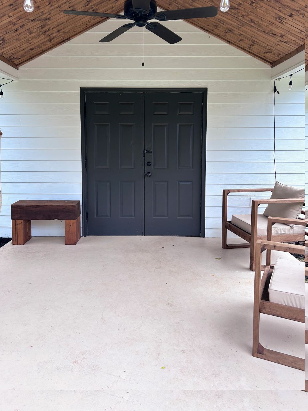 Covered porch with crisp exterior paint and stained ceiling